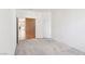 Open doorway of a white bedroom that leads to a tiled entryway with a fireplace at 3029 Paseo Hills Way, Henderson, NV 89052
