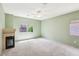 Spacious bedroom with cozy fireplace, ceiling fan and natural light from a nearby window at 3029 Paseo Hills Way, Henderson, NV 89052