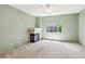 Comfortable bedroom with a fireplace, window, ceiling fan, and light green colored walls at 3029 Paseo Hills Way, Henderson, NV 89052
