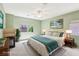Serene bedroom with fireplace, ceiling fan, and large window offering natural light at 3029 Paseo Hills Way, Henderson, NV 89052