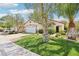 Curb view of a single-story house showing a large lawn, mature landscaping, and an attached two-car garage at 3029 Paseo Hills Way, Henderson, NV 89052