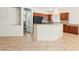 Bright kitchen with breakfast bar, tile floors, and open layout to other rooms at 3029 Paseo Hills Way, Henderson, NV 89052
