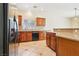 Stylish kitchen with stainless steel appliances and wood cabinets and backsplash at 3029 Paseo Hills Way, Henderson, NV 89052