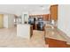 Open kitchen with granite countertops, wooden cabinetry, and stainless steel appliances at 3029 Paseo Hills Way, Henderson, NV 89052