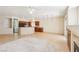 Open-concept living room adjacent to kitchen with large tile floors and light-colored walls at 3029 Paseo Hills Way, Henderson, NV 89052