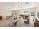 Bright living room with fireplace, dining area, and neutral color palette at 3029 Paseo Hills Way, Henderson, NV 89052
