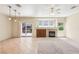 Spacious living room featuring fireplace, tile flooring, and sliding glass doors to the backyard at 3029 Paseo Hills Way, Henderson, NV 89052