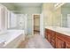 The main bathroom includes a separate shower and soaking tub plus a large vanity and walk-in closet at 3029 Paseo Hills Way, Henderson, NV 89052