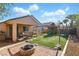 Backyard featuring a covered patio, outdoor seating, turf, playground, fire pit and desert landscaping at 3756 Toscanella Ave, Henderson, NV 89052