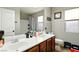 Bright bathroom featuring double sinks with dark wood cabinets, a large mirror, and a bathtub and shower combination at 3756 Toscanella Ave, Henderson, NV 89052