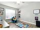 Bedroom featuring wood floors, decorated with a cartoon themed area rug and chair, with a large window at 3756 Toscanella Ave, Henderson, NV 89052