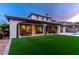 Wide view of the home's backyard, showcasing the patio, lawn, and pool area at 42 Carolina Cherry Dr, Las Vegas, NV 89141