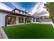 Wide view of the home's backyard, showcasing the patio, lawn, and pool area at 42 Carolina Cherry Dr, Las Vegas, NV 89141