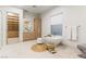 Bright primary bathroom with soaker tub, wooden vanity, and walk-in closet at 42 Carolina Cherry Dr, Las Vegas, NV 89141
