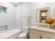 Modern bathroom with a clean, white vanity, large mirror, and tiled shower at 42 Carolina Cherry Dr, Las Vegas, NV 89141