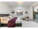 Bright bedroom with a large window, cozy chair, and a comfortable bed with decorative pillows at 42 Carolina Cherry Dr, Las Vegas, NV 89141