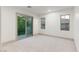 Bright bedroom with a large window, balcony access, and neutral carpeting at 42 Carolina Cherry Dr, Las Vegas, NV 89141