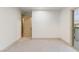 Bright bedroom with a large doorway, balcony access, and neutral carpeting at 42 Carolina Cherry Dr, Las Vegas, NV 89141