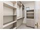 Spacious walk-in closet with custom shelves and built-in drawers at 42 Carolina Cherry Dr, Las Vegas, NV 89141
