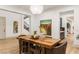 Open dining area features a large wooden table, modern chandelier, and artwork at 42 Carolina Cherry Dr, Las Vegas, NV 89141