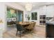 Bright dining area with a view of the outdoor patio, features stylish furnishings and stainless steel appliances at 42 Carolina Cherry Dr, Las Vegas, NV 89141