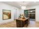 Bright dining room features wood table and modern chandelier fixture with slider to backyard at 42 Carolina Cherry Dr, Las Vegas, NV 89141