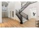 Inviting entryway featuring hardwood floors, staircase with iron railings, and soaring ceilings at 42 Carolina Cherry Dr, Las Vegas, NV 89141