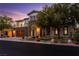 Inviting two-story home featuring stone accents, a spacious garage, and professionally landscaped yard at 42 Carolina Cherry Dr, Las Vegas, NV 89141