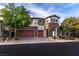 Charming two-story house with stone accents, a spacious two-car garage, and lush landscaping at 42 Carolina Cherry Dr, Las Vegas, NV 89141