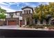 Charming two-story house with stone accents, a spacious two-car garage, and lush landscaping at 42 Carolina Cherry Dr, Las Vegas, NV 89141
