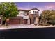 Inviting two-story home featuring stone accents, a spacious garage, and professionally landscaped yard at 42 Carolina Cherry Dr, Las Vegas, NV 89141