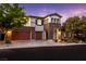 Inviting two-story home featuring stone accents, a spacious garage, and professionally landscaped yard at 42 Carolina Cherry Dr, Las Vegas, NV 89141