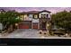 Beautiful two-story home features a stone facade, three-car garage and desert landscaping at 42 Carolina Cherry Dr, Las Vegas, NV 89141