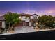 Elegant two-story home boasts a stone and stucco facade, desert landscaping, and a three-car garage at 42 Carolina Cherry Dr, Las Vegas, NV 89141
