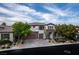 Beautiful home with a stone and stucco facade, three-car garage, and landscaped front yard at 42 Carolina Cherry Dr, Las Vegas, NV 89141