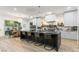 Modern open kitchen featuring an island with seating, sleek cabinets, and designer finishes at 42 Carolina Cherry Dr, Las Vegas, NV 89141