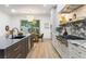 Stylish kitchen with stainless steel appliances, marble accents, and an adjacent dining area at 42 Carolina Cherry Dr, Las Vegas, NV 89141