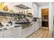 Updated kitchen features marble countertops, custom cabinetry, and stainless steel appliances at 42 Carolina Cherry Dr, Las Vegas, NV 89141