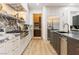 Modern kitchen with marble backsplash, stainless steel appliances, and sleek wooden floors at 42 Carolina Cherry Dr, Las Vegas, NV 89141