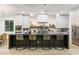 Contemporary kitchen with bar seating, stainless steel appliances, and marble countertops at 42 Carolina Cherry Dr, Las Vegas, NV 89141