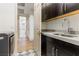 Well-equipped laundry room with modern washer, sink, and cabinet space at 42 Carolina Cherry Dr, Las Vegas, NV 89141