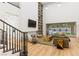 Bright living room with a fireplace, floor-to-ceiling shelving, and sliding doors to the backyard at 42 Carolina Cherry Dr, Las Vegas, NV 89141