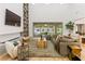 Bright and airy living room featuring tall shelving, a fireplace, and seamless indoor/outdoor living at 42 Carolina Cherry Dr, Las Vegas, NV 89141