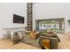 Open living space featuring floor-to-ceiling shelving, a fireplace, and expansive backyard view at 42 Carolina Cherry Dr, Las Vegas, NV 89141