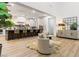 Bright living room with view into kitchen, features a decorative mirror and a cozy chair at 42 Carolina Cherry Dr, Las Vegas, NV 89141