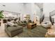 Bright living room featuring an open floorplan, high ceilings, and a cozy sectional sofa at 42 Carolina Cherry Dr, Las Vegas, NV 89141