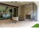 Cozy covered patio with a fireplace and comfortable seating, perfect for outdoor relaxation at 42 Carolina Cherry Dr, Las Vegas, NV 89141
