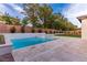 Gorgeous backyard features a modern style pool, a hot tub and ample patio space for entertaining at 42 Carolina Cherry Dr, Las Vegas, NV 89141