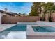 Backyard pool and spa offers a tranquil outdoor space with privacy walls and blue skies at 42 Carolina Cherry Dr, Las Vegas, NV 89141