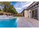 Gorgeous backyard features a modern style pool, a hot tub and ample patio space for entertaining at 42 Carolina Cherry Dr, Las Vegas, NV 89141